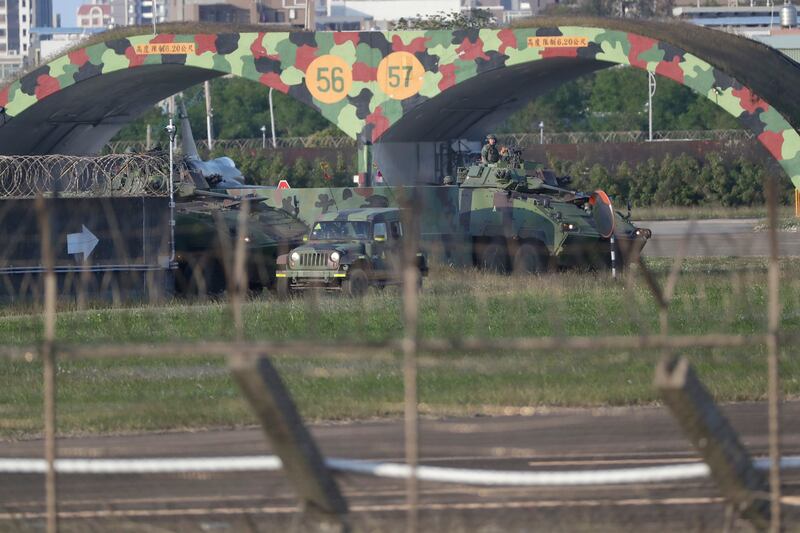 Taiwan army ground force members ride on vehicles at an airbase in Hsinchu, northern Taiwan (Chiang Ying-ying/AP)