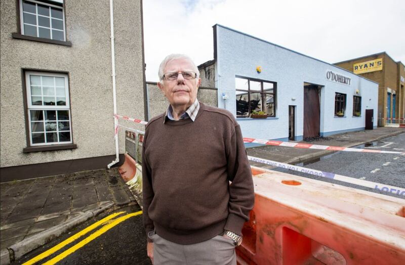 &nbsp;Charlie Tighe standing outside his home next to O'Doherty and Sons Coffin and Casket manufacturers in Strabane, Co Tyrone after a blaze broke out yesterday afternoon. Picture by&nbsp;Liam McBurney/PA Wire