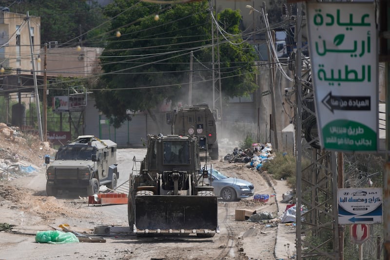 Bulldozers have been seen in the streets at the West Bank refugee camp of Al-Faraa (AP)