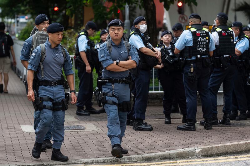 Police officers stand guard outside the West Kowloon Magistrates’ Courts in Hong Kong (Chan Long Hei/AP)