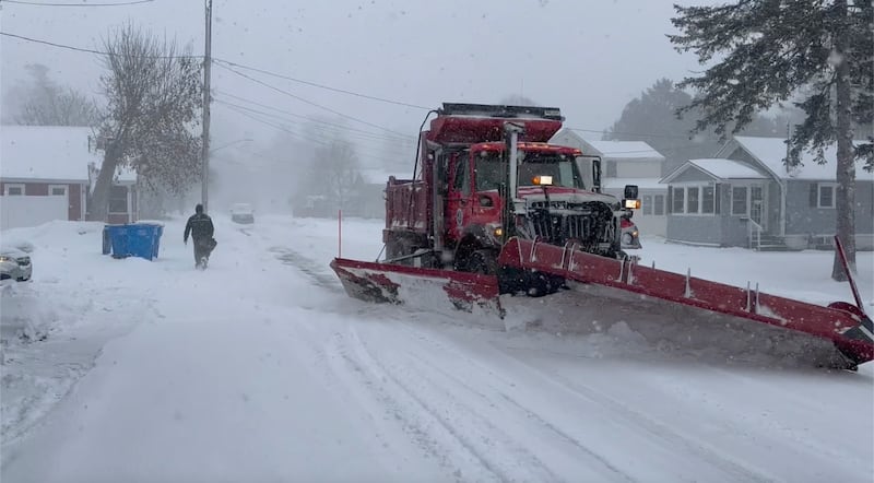 Snow is cleared from a street in Lowville, New York (Cara Anna/AP)