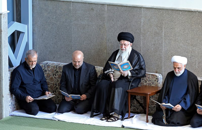 Ayatollah Ali Khamenei, second right, judiciary chief Gholam Hossein Mohseni Ejehei, right, parliament speaker Mohammad Bagher Qalibaf, second left, and President Masoud Pezeshkian read the Koran in a ceremony commemorating killed Hezbollah leader Hassan Nasrallah, at Imam Khomeini grand mosque in Tehran, Iran (Office of the Iranian Supreme Leader via AP)