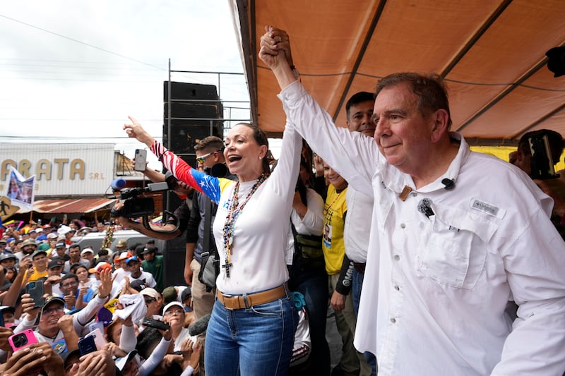 Presidential candidate Edmundo Gonzalez and opposition leader Maria Corina Machado greet supporters at a campaign rally in Barinas (Ariana Cubillos/AP)