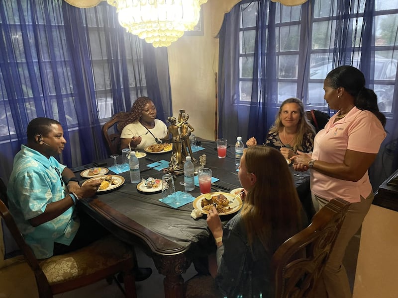 People to People ambassador Kwame Russell (left) entertains visitors in his home (Bahamas Tourist Board)