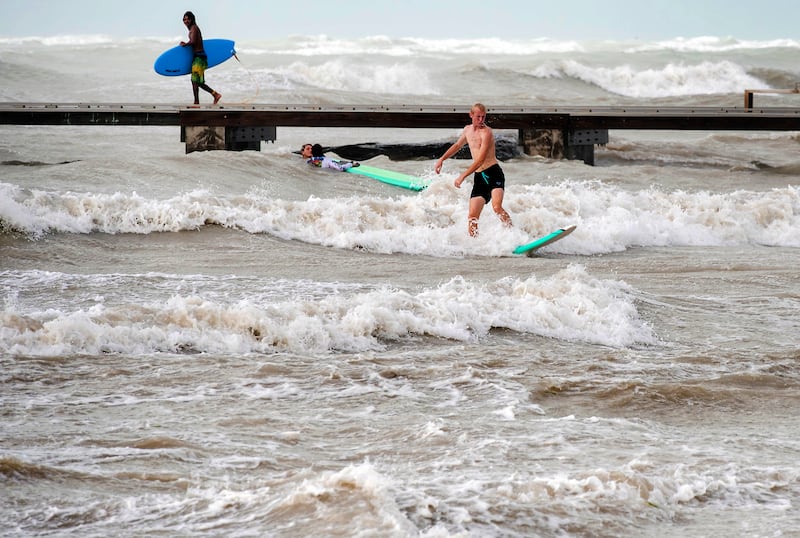 Surfers take advantage of heavy winds along Higgs Beach in Key West, Florida (Rob O’Neal/The Key West Citizen via AP)