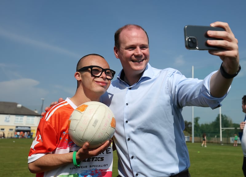 Sports Minister Gordon  Lyons with Jay Beattie  during an GAA event at Kickams Creggan on Saturday.
PICTURE COLM LENAGHAN