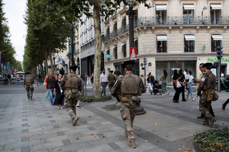 Soldiers patrol on the Champs-Elysees in Paris ahead of the Paralympic Games (Aurelien Morissard/AP)