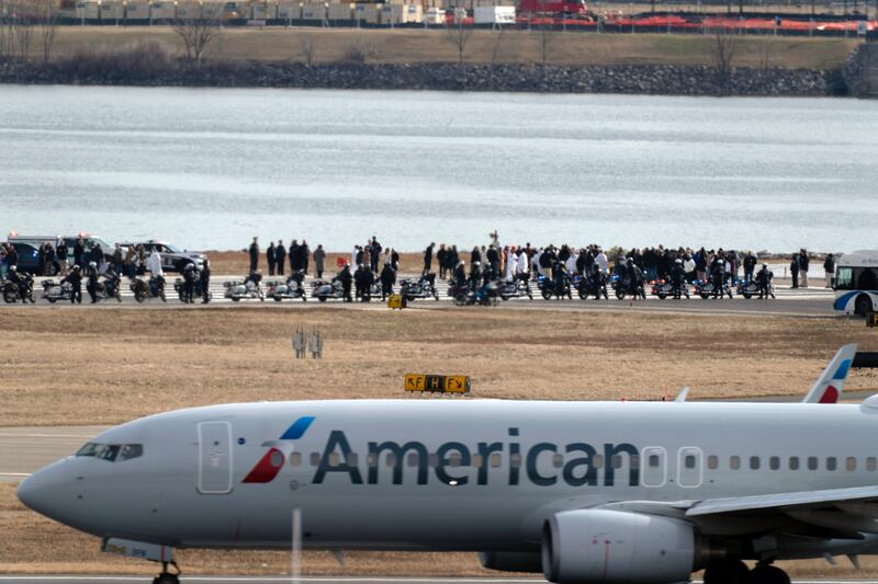 Families of the victims stand near the wreckage site in the Potomac River (Jose Luis Magana/AP)