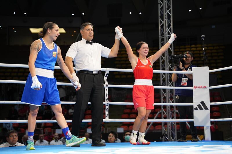 Daina Moorhouse has her hand raised after her win over Zlatislava Chukanova of Bulgaria