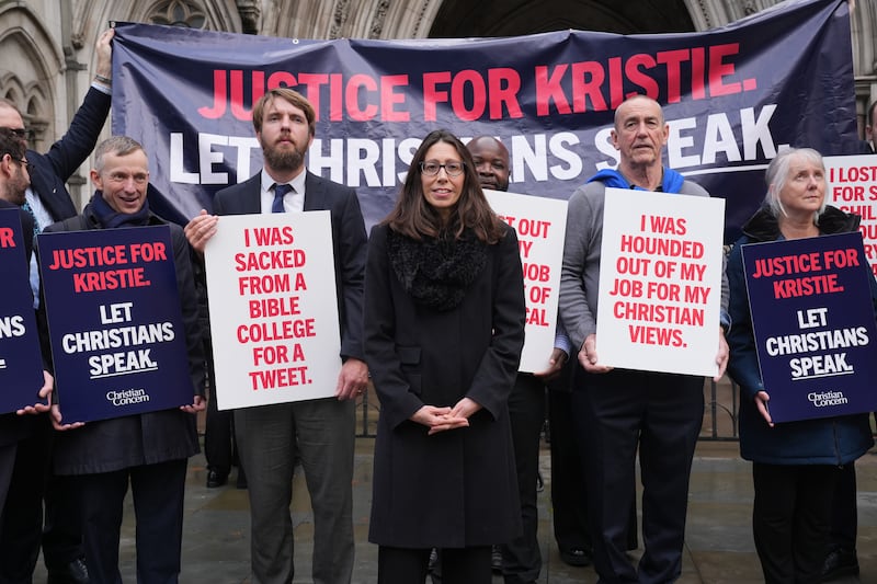 Christian school worker Kristie Higgs (centre) with supporters outside the Royal Courts Of Justice in London