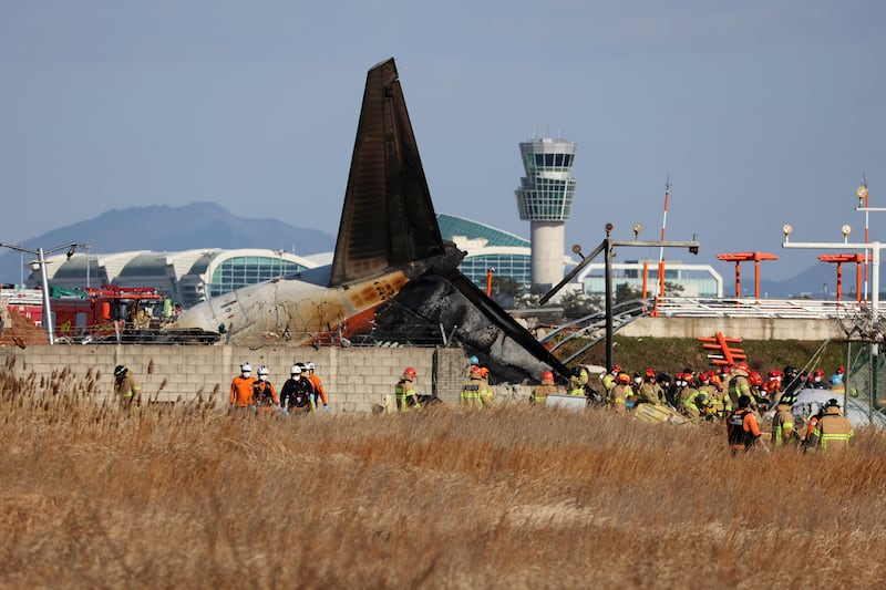 Firefighters and rescue team members work at Muan International Airport (Cho Nam-soo/Yonhap/AP)