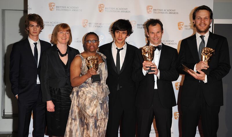 Pier Wilkie, Otto Bathurst and Peter Moffat pose with Ben Whishaw, centre, and presenter Andrew Garfield, far left, after Criminal Justice wins the award for Bafta drama serial award