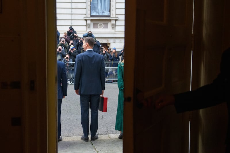 Then chancellor Jeremy Hunt stands outside 11 Downing Street, London, to face the media with his ministerial box, before delivering his budget in March