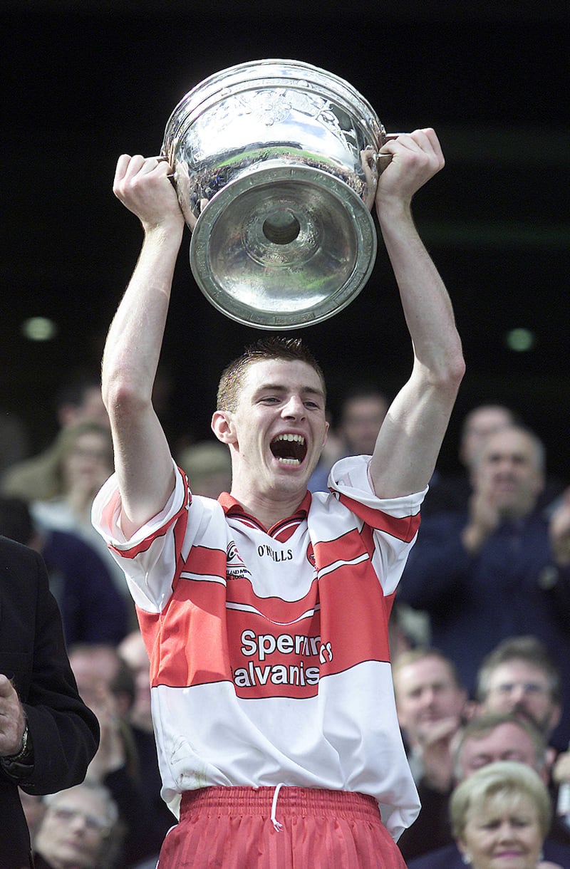 Derry's Gerard O'Kane pictured raising the Tom Markham cup as captain of the 2002 Derry All-Ireland minor winning side. (Picture: Hugh Russell)