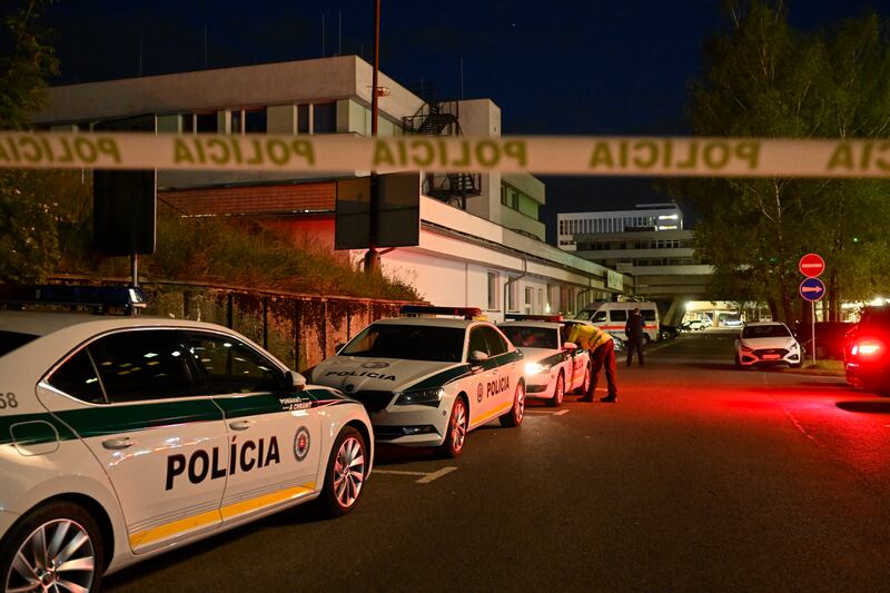 Police cars are parked outside the hospital where the prime minister is undergoing treatment (Denes Erdos/AP)