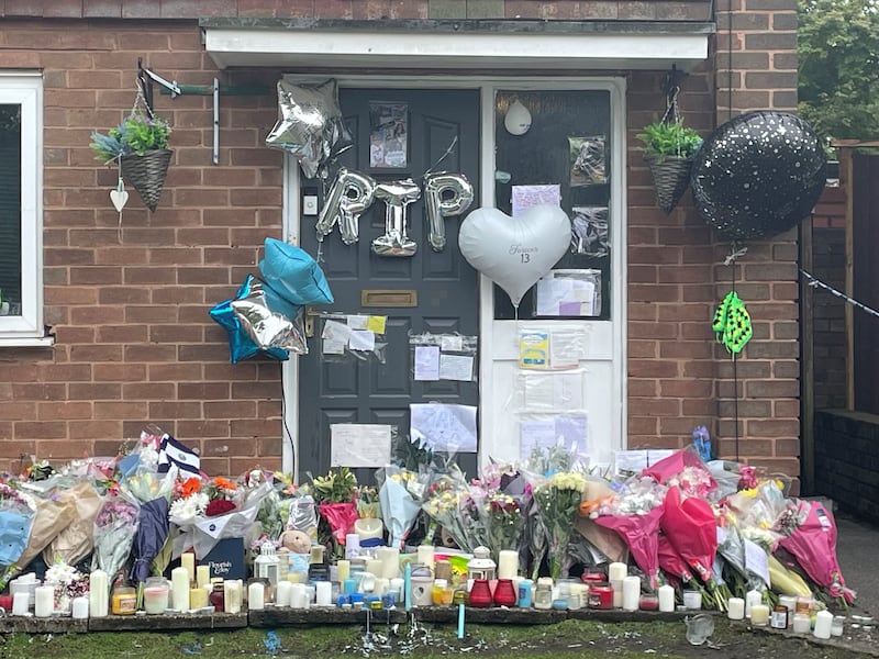 Dozens of bunches of flowers, candles, balloons and teddies have been left outside the scene of the fatal stabbing