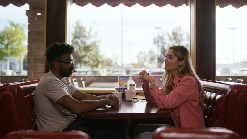 Romesh Ranganathan and Dr Julia Shaw discussing the Tupac Shakur case in a diner