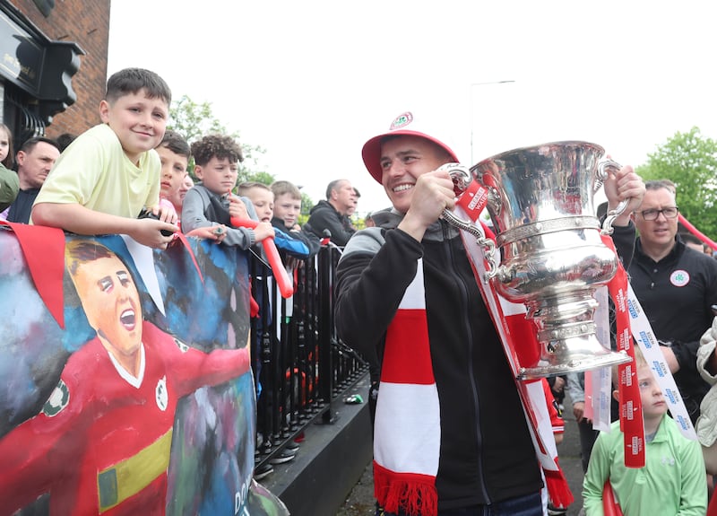 Cliftonville’s Ronan Hale celebrates with the fans during an open top bus tour across Belfast after winning the Irish Cup oat Windsor on Saturday.
PIC COLM LENAGAN