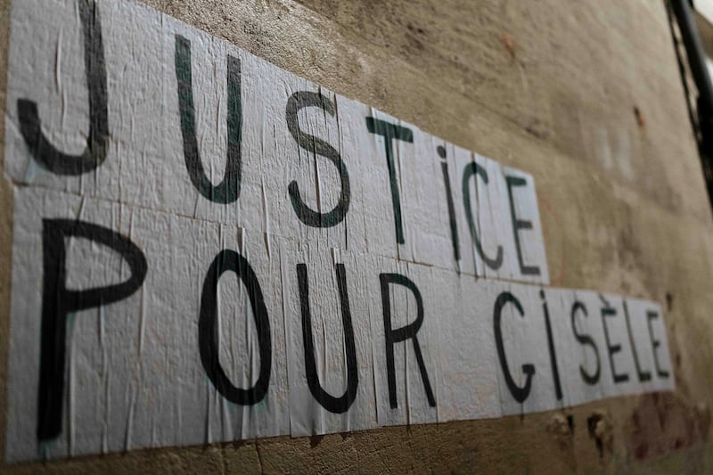 Members of a feminist collective with a message of support for Gisele Pelicot (Lewis Joly/AP)