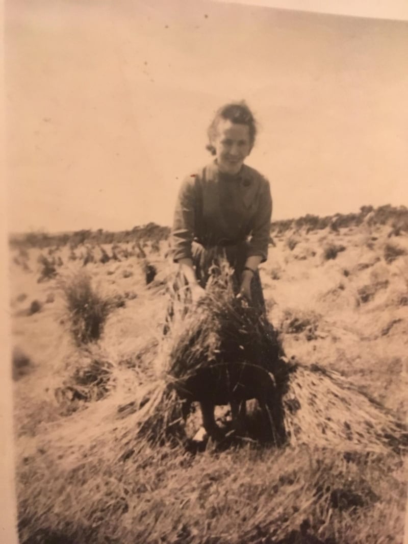 Kathleen Kelly collecting straw on a farm