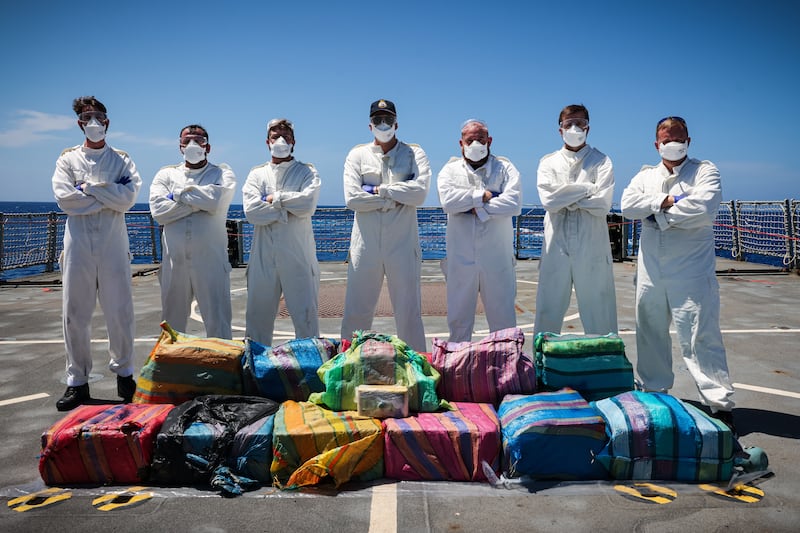 Sailors pose with seized cocaine from a narco-sub in the Caribbean