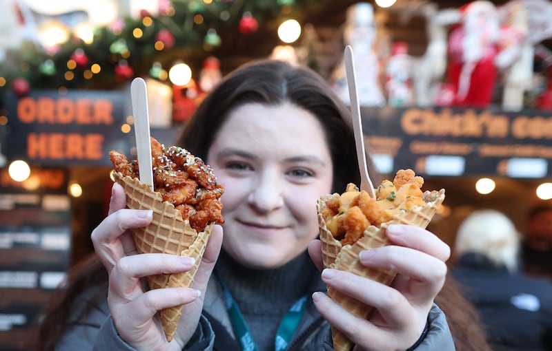 Irish News Sophie Clarkes tastes the Pizza at the Belfast Christmas Market.
PICTURE COLM LENAGHAN