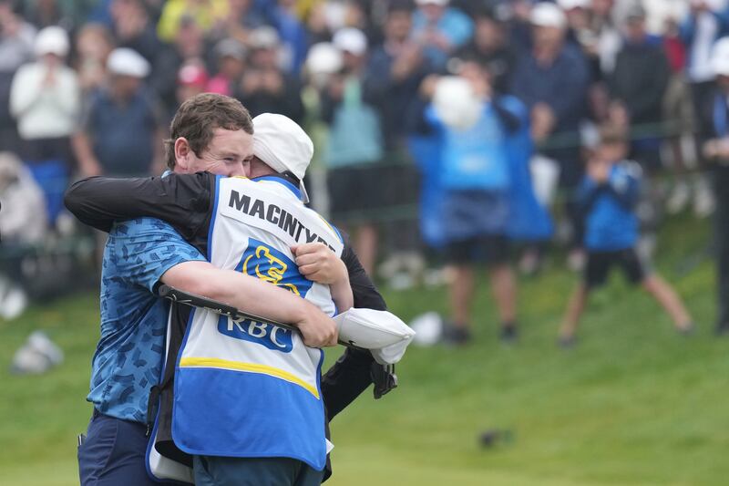 Scotland’s Robert MacIntyre celebrates with his father Dougie after winning the RBC Canadian Open (Nathan Denette/The Canadian Press via AP)