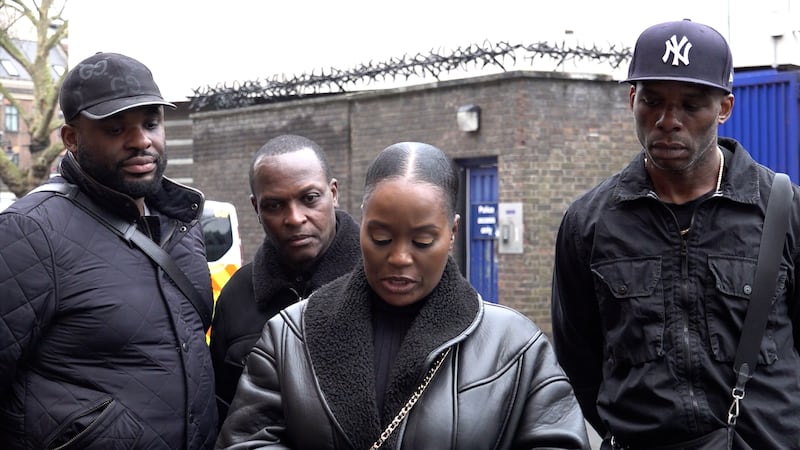 Victoria Tawiah, the sister of James Akinwande, who was 18 when he was stabbed in 1994, accompanied by her family as she makes a statement outside Brixton Police Station