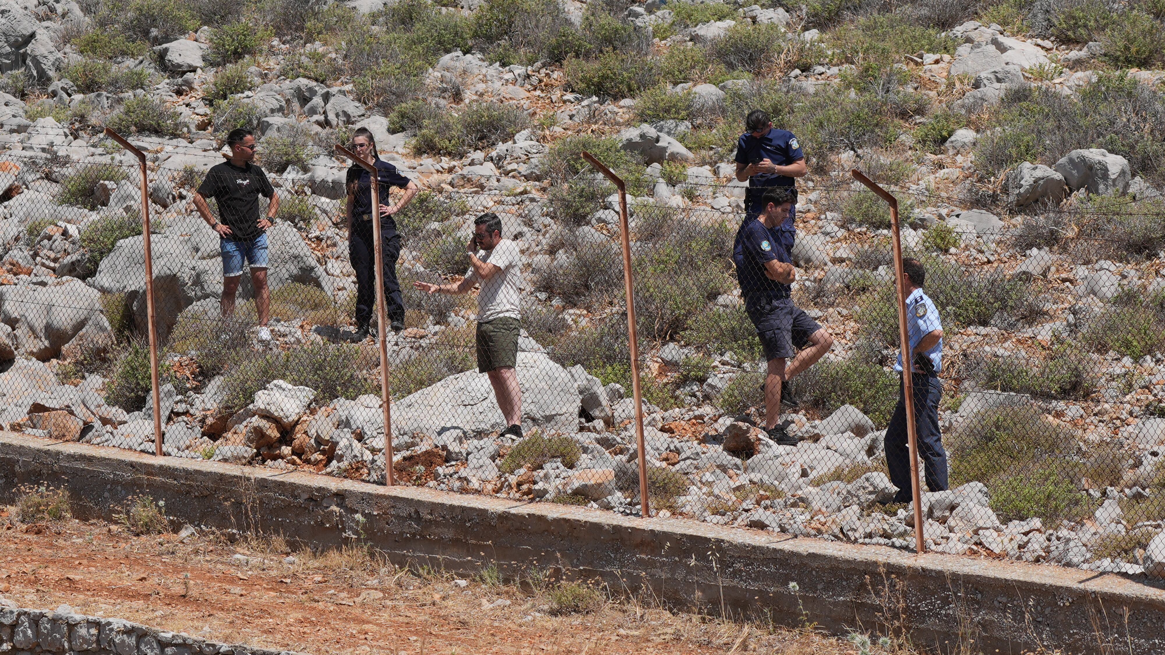 A search team scours a rocky area on Symi, Greece