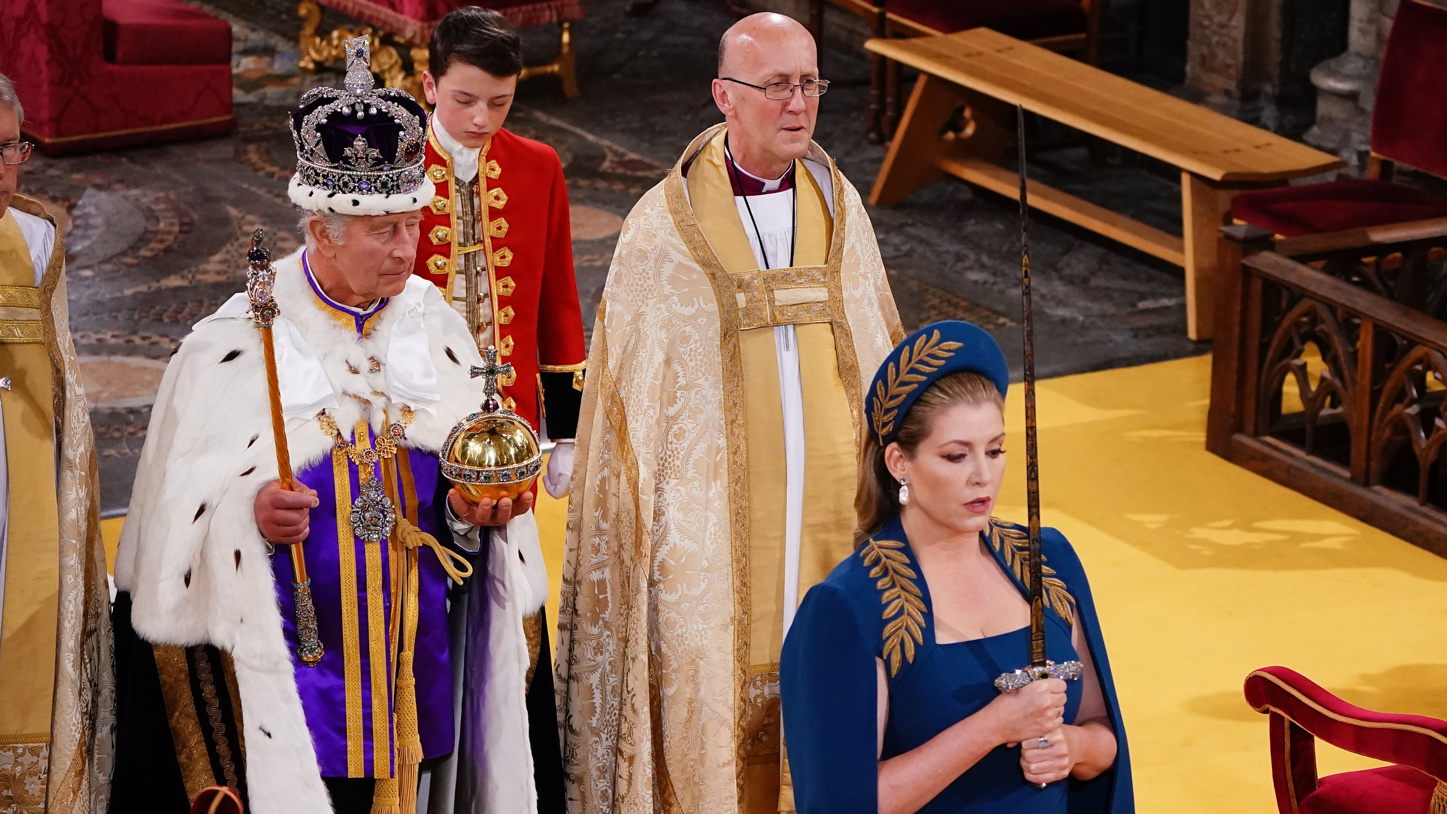 Lord President of the Council, Penny Mordaunt, holding the Sword of State walking ahead of King Charles III during his coronation ceremony in Westminster Abbey