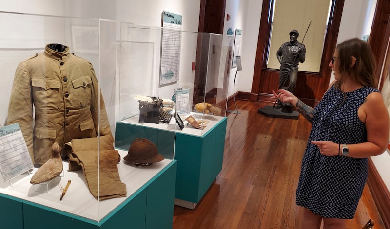 Curator Cori Convertito shows off Ernest Hemingway’s First World War ambulance driver uniform and other belongings at Key West Museum of Art & History at the Custom House in Key West (David Fischer/AP)