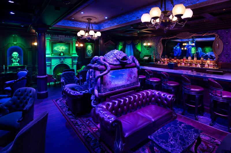 The interior of The Haunted Mansion Parlor on the Disney Treasure including the aquarium centrepiece