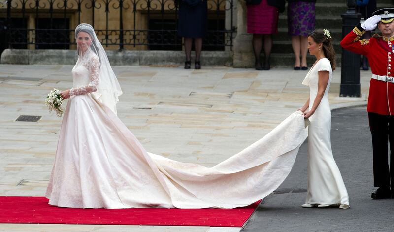 Burton designed both Kate and Pippa’s royal wedding dresses