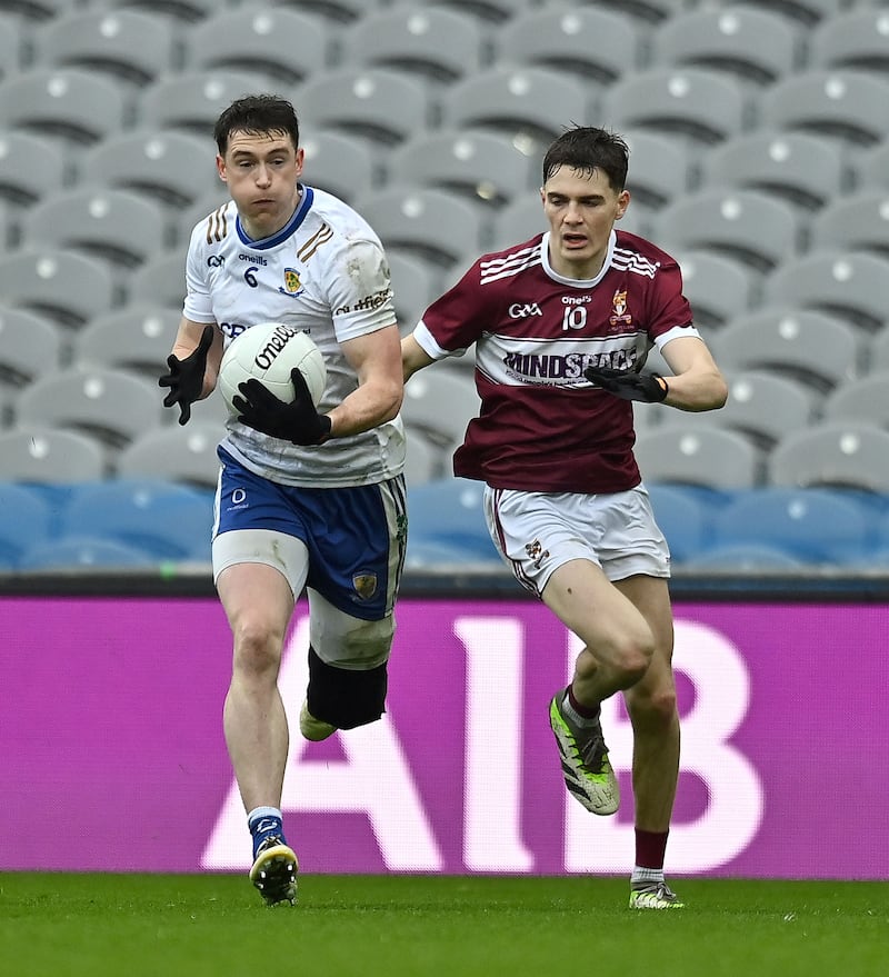 Ballinderry captain Gareth McKinless playing with a heavily-strapped left leg, runs away from Diarmuid Coggins of Crossmalina.