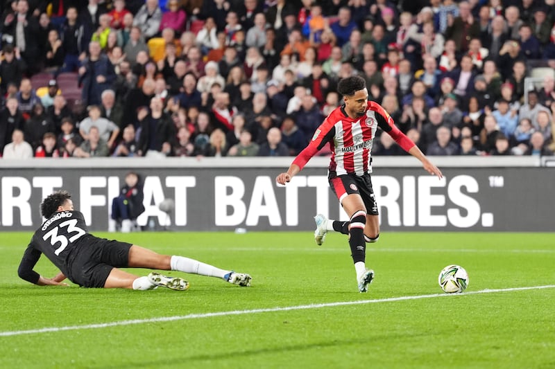 Kevin Schade, right, steadies himself to score Brentford’s opener