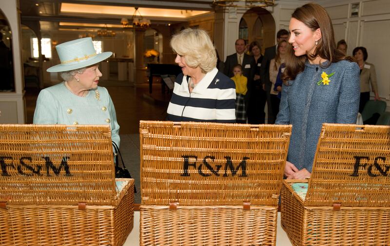 Queen Elizabeth II, Queen Camilla and the Princess of Wales during a visit to Fortnum and Mason