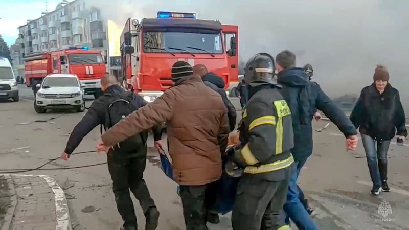 Rescuers carry a wounded person after shelling in Belgorod (Russia Emergency Situations Ministry telegram channel via AP)