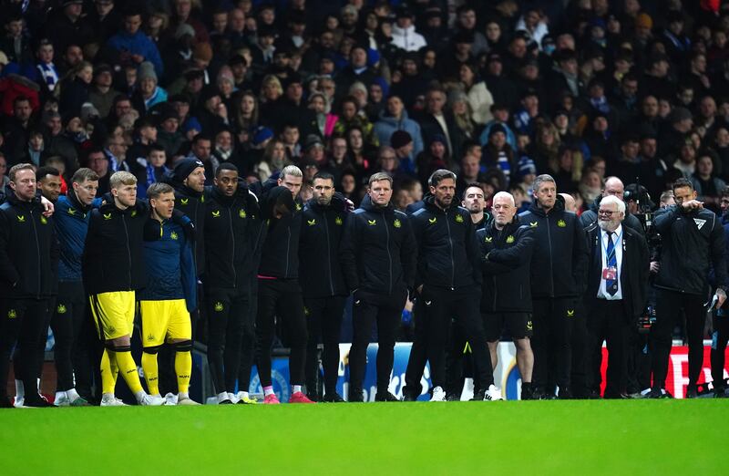 Eddie Howe, centre, and his staff and substitutes watch the penalty shoot-out