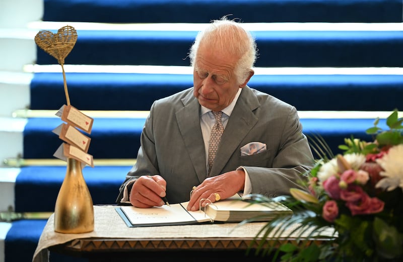 The King signed a book of condolence in the town hall