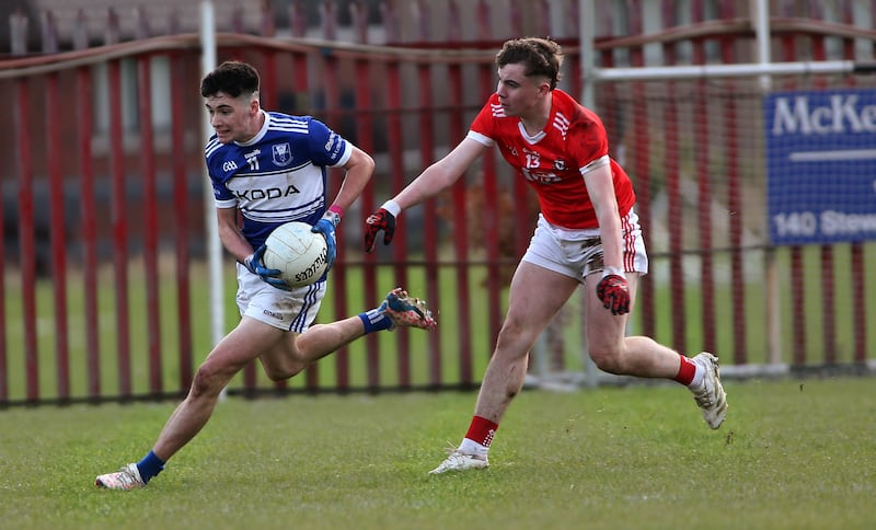 Four Masters Turlough Carr escapes  Magherafelt's Kian Maynes' tackle in yesterday's Ulster Club Minor Final at St Pauls GAC