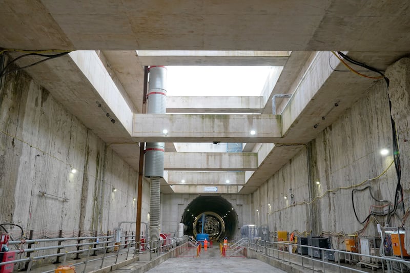 HS2 workers walk towards the upline tunnel at the bottom of the Old Oak Common station box site during preparations for completing tunnelling to London Euston