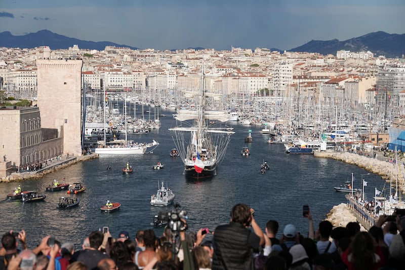 Crowds watch as the Belem, the three-masted sailing ship bringing the Olympic flame from Greece, enters Marseille (Laurent Cipriani/AP)