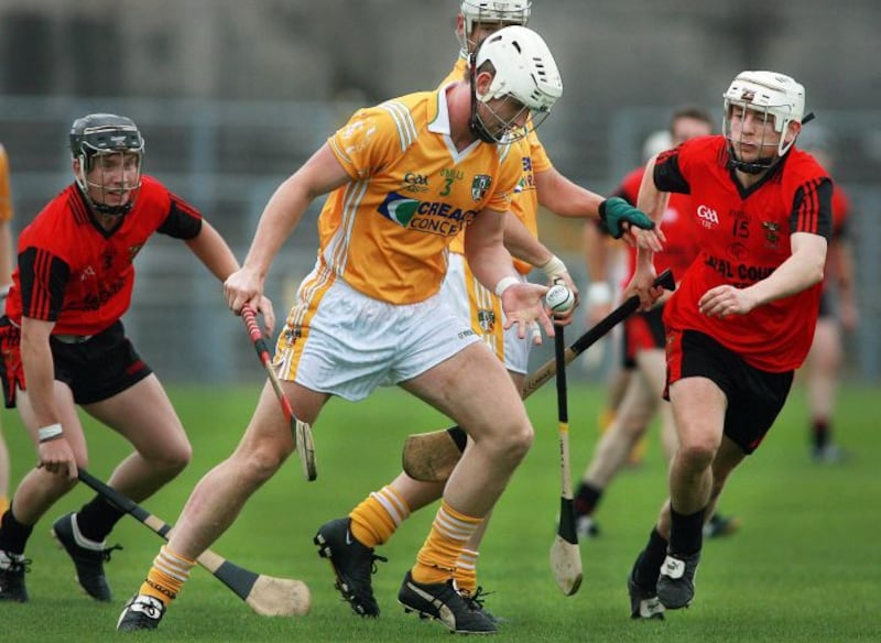 Antrim's Neil McGarry is put under pressure by Down's Stephen Clarke and James Coyle during the 2013 Ulster SHC final&nbsp;