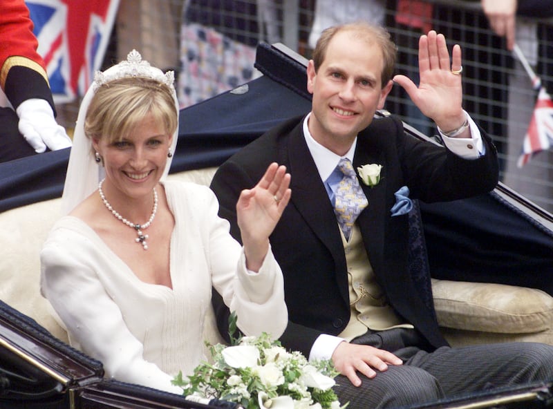 Smiling newlyweds Sophie and Edward, the new Earl and Countess of Wessex, wave to the crowds after their wedding at St George’s Chapel in 1999