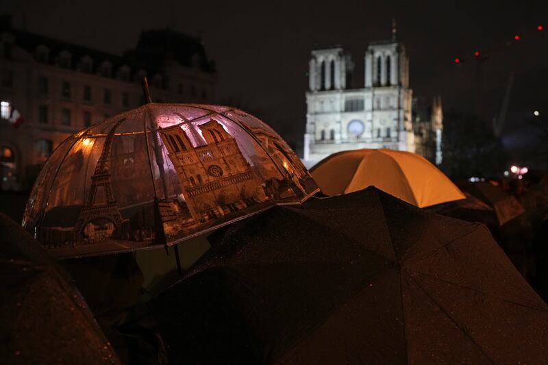 Spectators gather outside Notre Dame Cathedral (Alessandra Tarantino/AP)