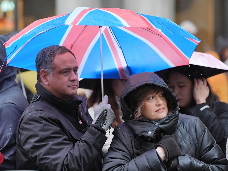 Rain falls as people gather to watch the New Year’s Day Parade in central London