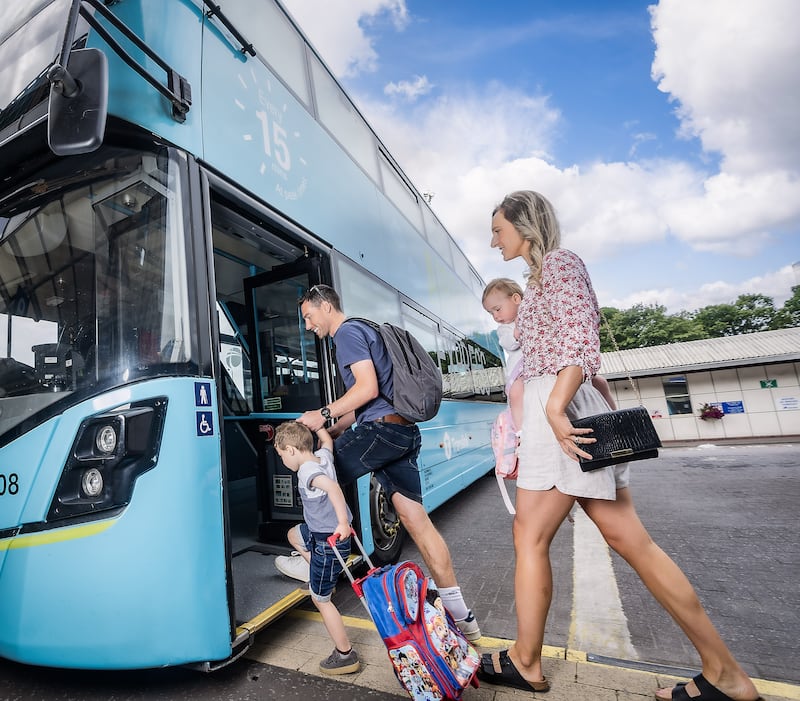 Rob and Rebecca Hillis with their children Cameron and Ada boarding the Airport Express 300 service