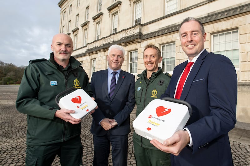 Education Minister Paul Givan with Fearghal McKinney of the British Heart Foundation Northern Ireland, and members of the NIAS