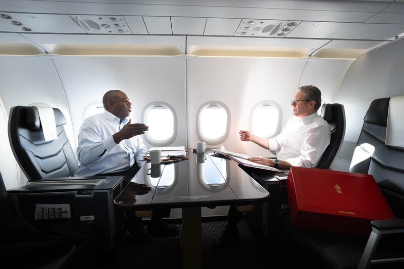 Prime Minister Sir Keir Starmer and Foreign Secretary David Lammy work on the plane as they fly to Washington DC for talks with President Joe Biden