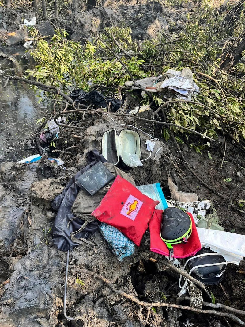 Passengers’ belongings at the crash site (Chachoengsao’s Public Relations Department/AP)